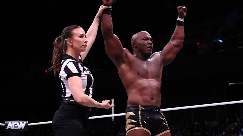 Aubrey Edwards raises Shelton Benjamin's hand