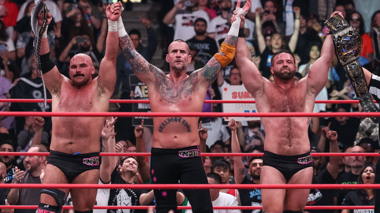 CM Punk and FTR raise their arms