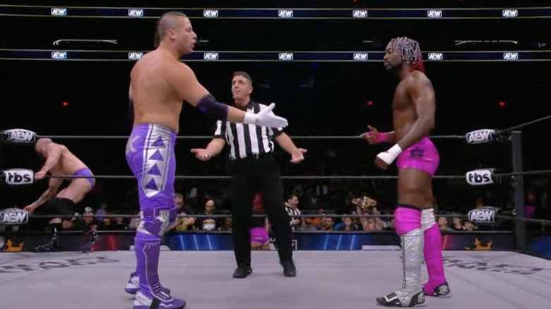 Taven offering his hand to Sparks