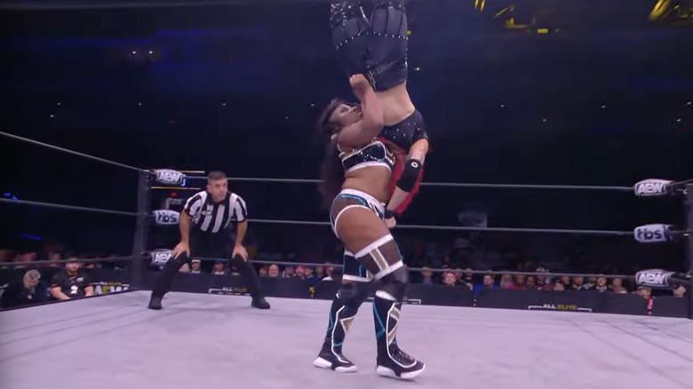 Athena looking for a vertical suplex on Threat