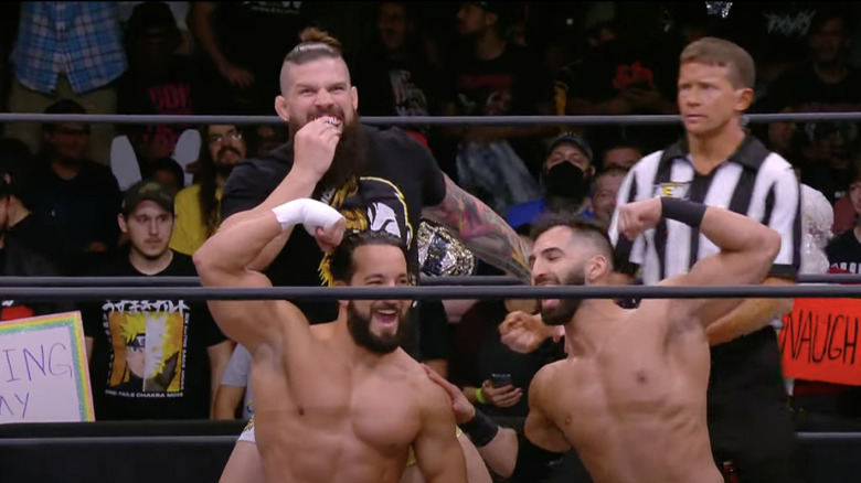 Varsity Athletes and Daivari posing in the ring