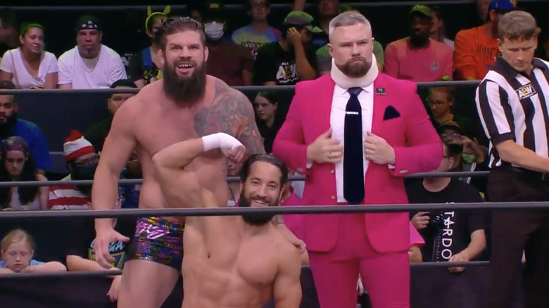 Woods, Nese and Sterling posing in the ring