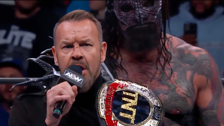 Christian Cage speaks into microphone as Killswitch looks on