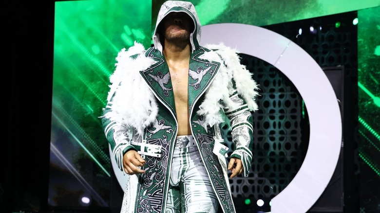 Wil Ospreay makes his AEW Worlds End entrance in a hooded white ring jacket.