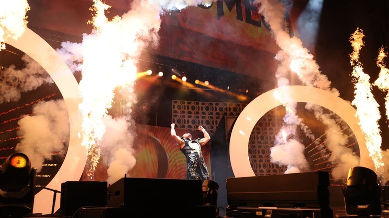 Kenny Omega poses as pyro goes off during his entrance on "AEW Dynamite."