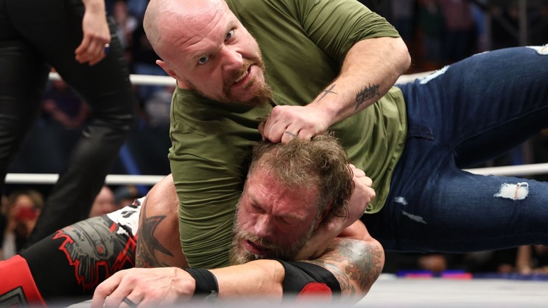 Jon Moxley choking out Cope on "AEW Dynamite."