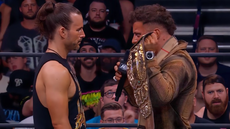 MJF holding up the world title to Adam Cole