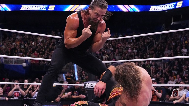 Jay White stands over Adam Page