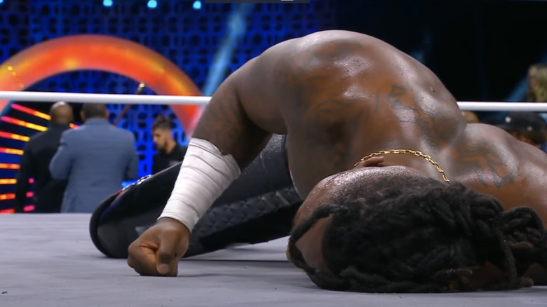 Swerve Strickland lying beaten on the mat as The Hurt Syndicate leave up the ramp on "AEW Dynamite."