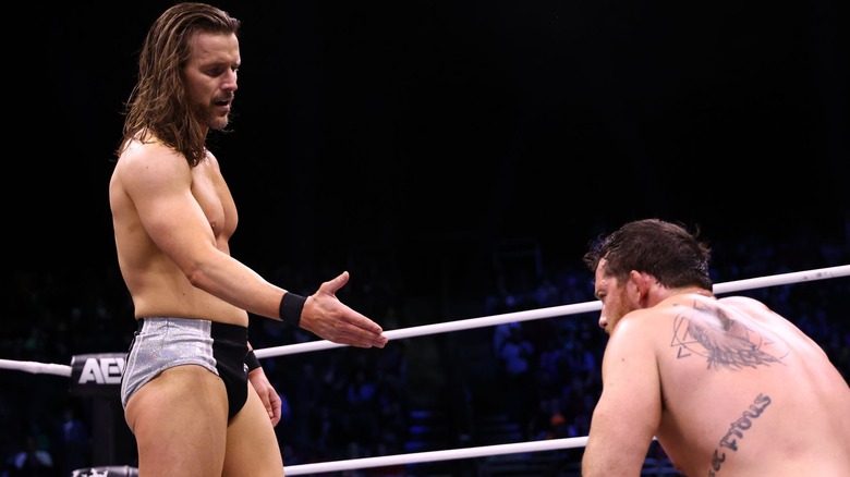 Adam Cole offers a hand to Kyle O'Reilly