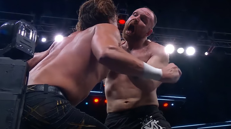 Jon Moxley prepares to bite Jay White