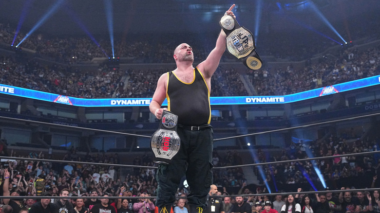 Eddie Kingston holding title belts