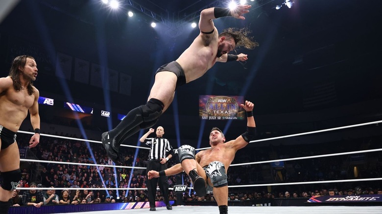 Adam Cole watches while PAC flies at Roderick Strong on "AEW Dynamite."