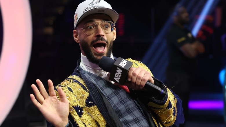 Ricochet speaks into a microphone on "AEW Dynamite."