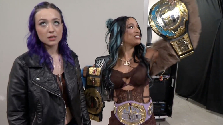 Billie Starkz rolls her eyes as Mercedes Mone shows off her titles backstage on "AEW Dynamite."