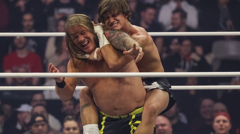 HOOK with choke hold on Chris Jericho