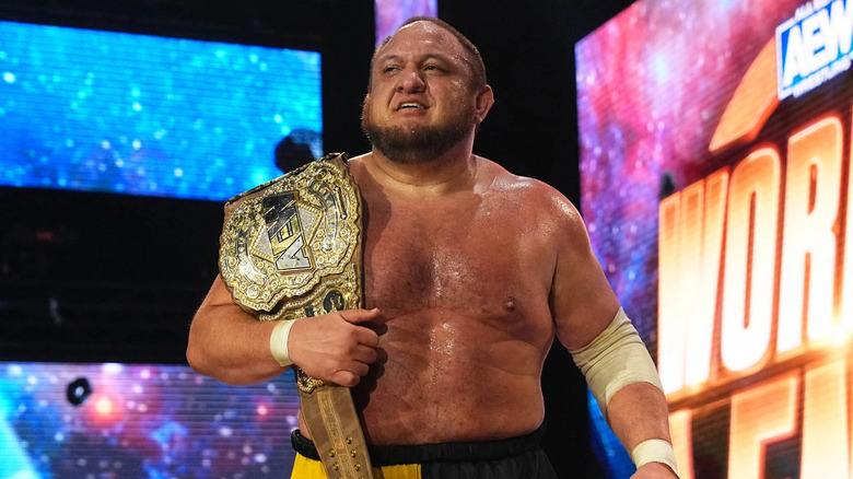Samoa Joe holding title belt