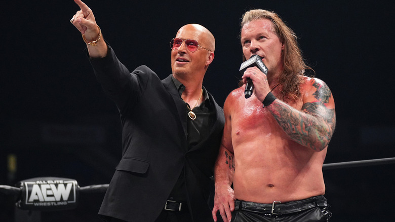 Don Callis pointing while Chris Jericho talks