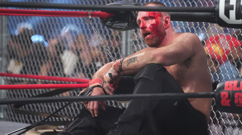 Jon Moxley sitting in cage