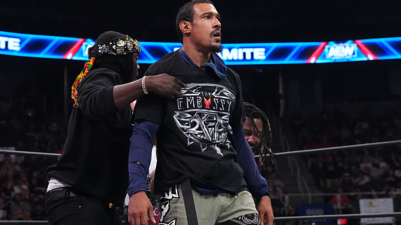 AR Fox putting on Embassy shirt