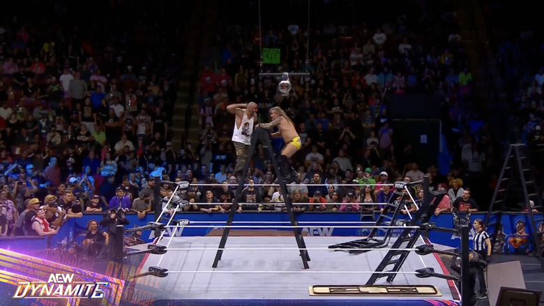 Mark and Jericho on a ladder in the middle of the ring