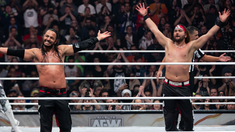 The Young Bucks pose in the ring