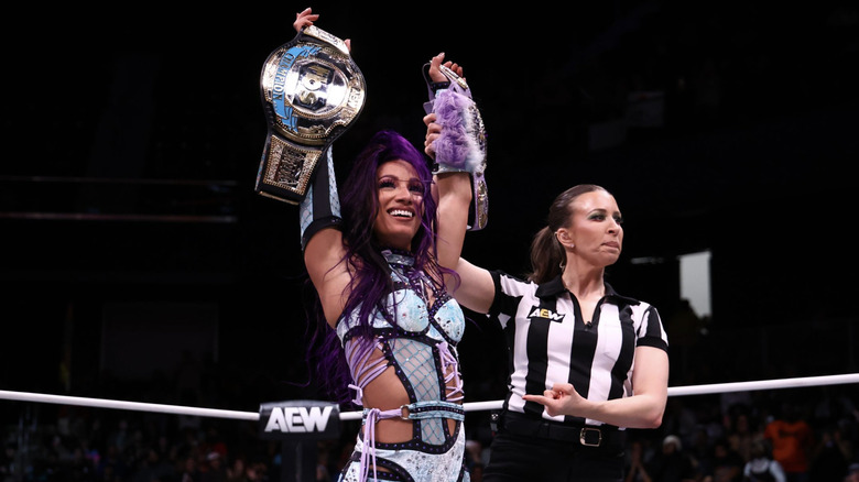 Mone holding up her TBS Championship