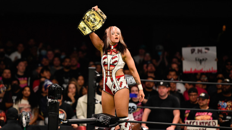 Jamie Hayter poses with her title