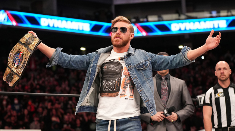 Orange Cassidy poses with the title