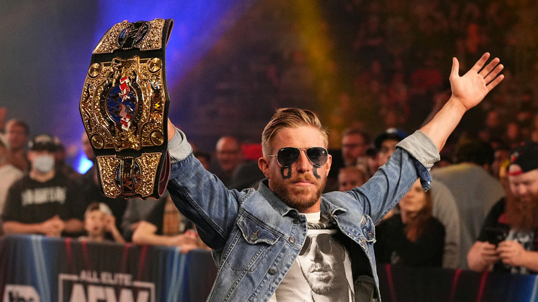 Orange Cassidy poses with the AEW International Championship