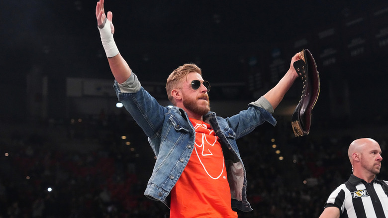 Orange Cassidy poses with his title