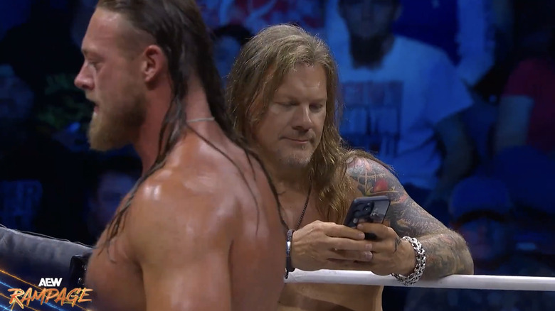 Jericho checking his phone on the apron