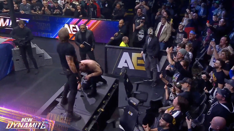 Cope and Moxley brawling on top of the announce desk