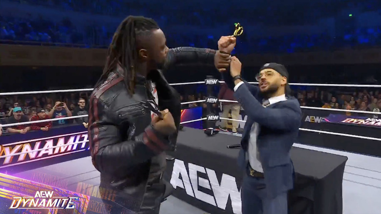 Strickland and Ricochet fighting over the scissors