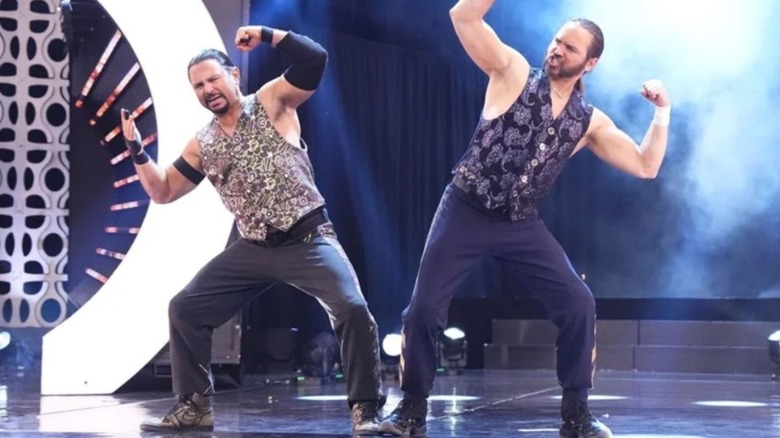 Matthew and Nicholas Jackson, the Young Bucks, pose on the stage before a match on AEW TV.