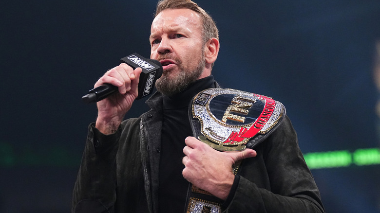 Christian Cage with microphone and title belt