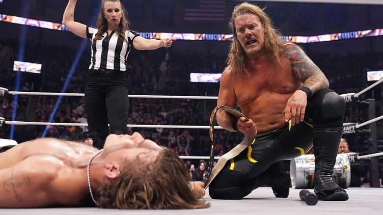Chris Jericho kneels over HOOK
