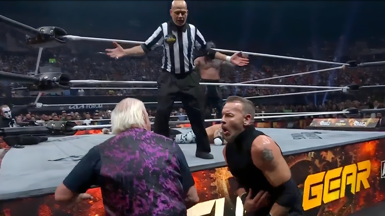 Referee watches Ric Flair hit Christian