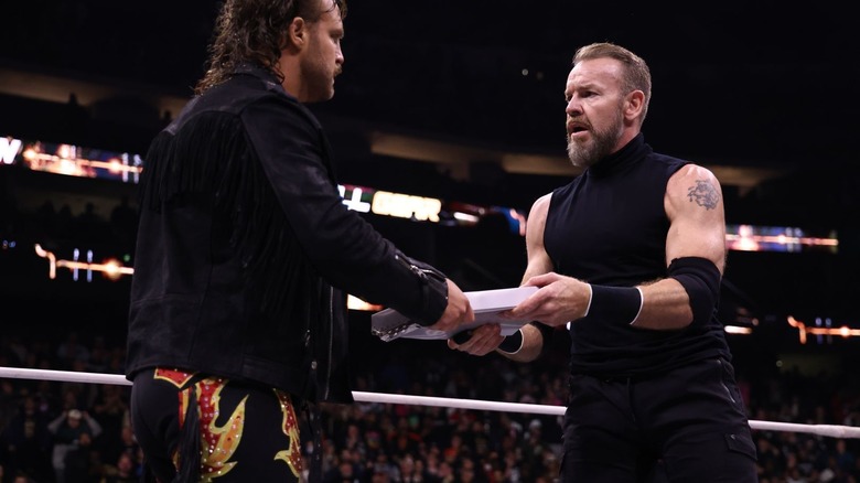 Adam Page and Christian Cage holding onto contract.