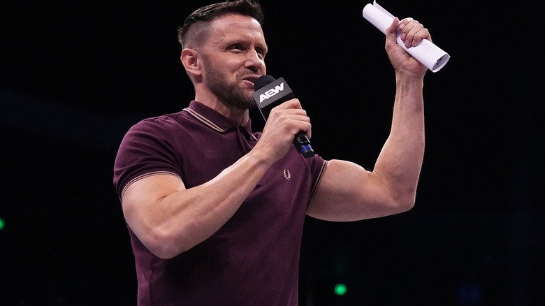 Nigel McGuinness with contract and microphone