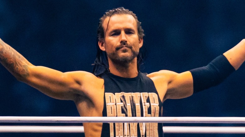 Adam Cole, arms raised out