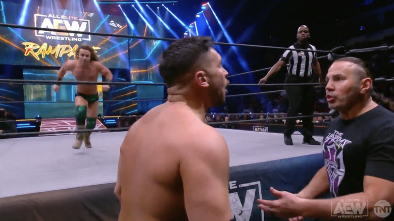 Page and Hardy arguing as Jungle Boy charges at Page