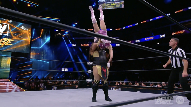 Rose holding Riho up for a delayed vertical suplex