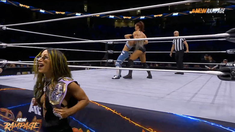 Kamille and Lynn in the ring as Mone watches from the outside