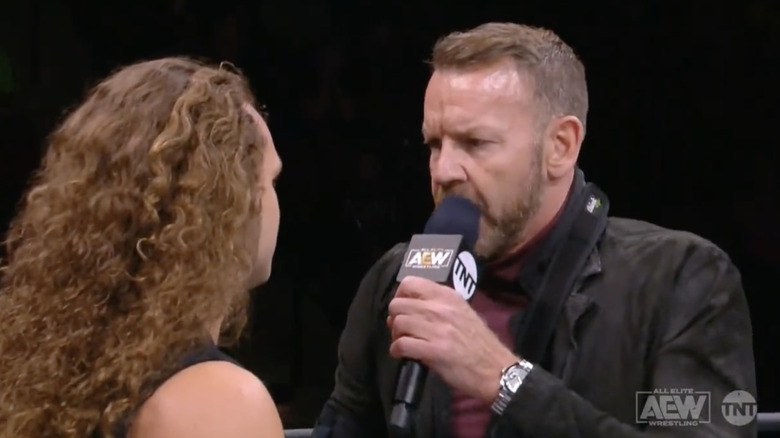 Cage and Jungle Boy talking in the ring