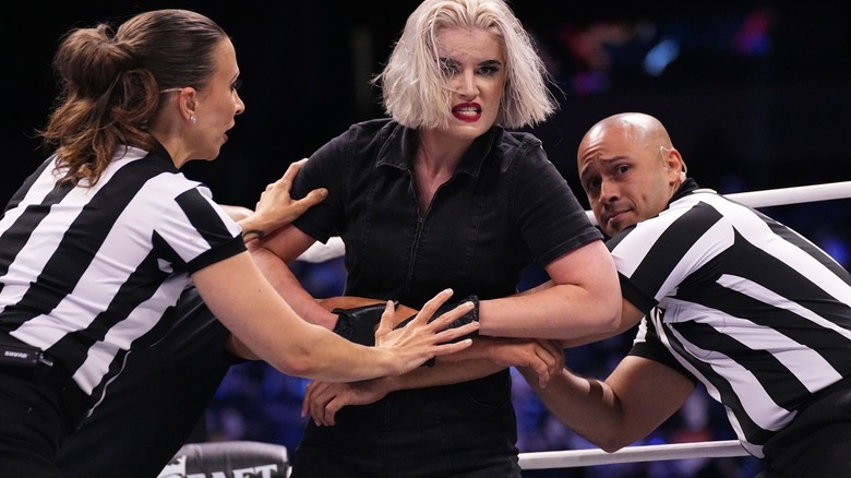 AEW referees restrain Toni Storm