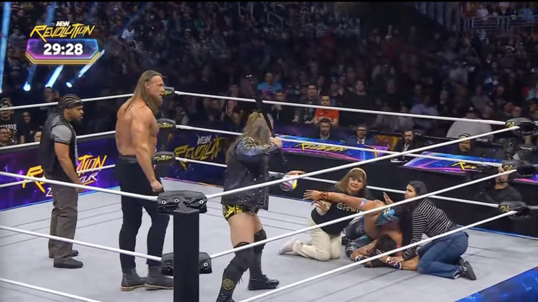 Jericho, Bill, and Keith standing over Bandido, Gravity, and Gravity's family