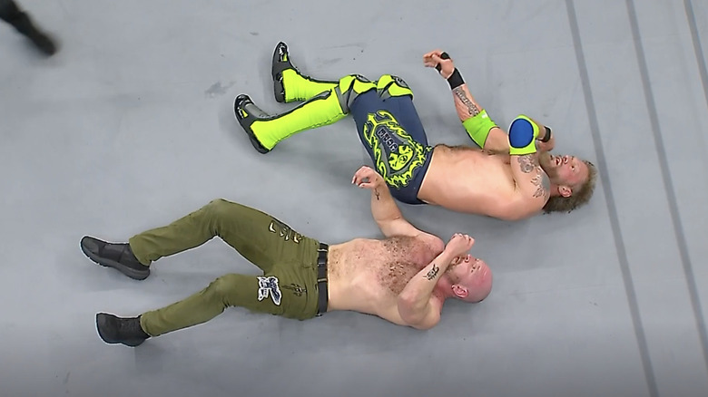 Cope and Moxley laying in the ring