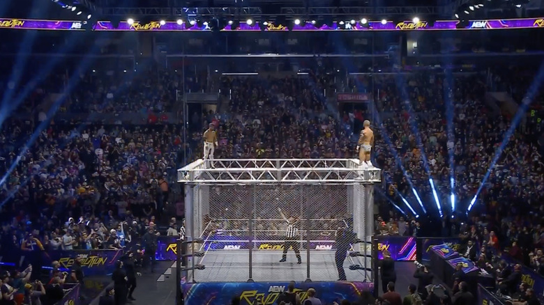 Ospreay and Fletcher on top of the cage