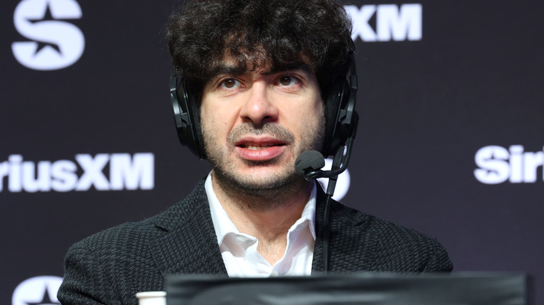 Tony Khan awaits a question during a press event